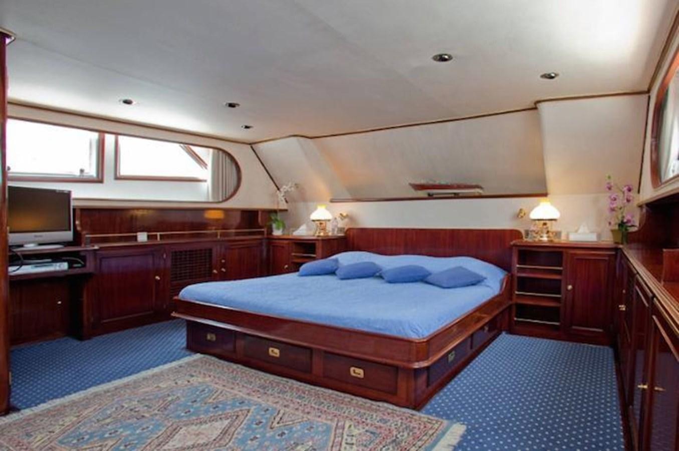 a bedroom with a bed and a television aboard MISS EVA Yacht for Sale
