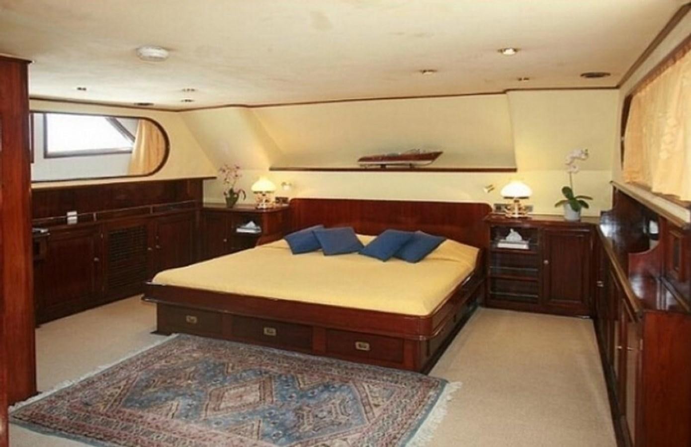 a bedroom with a bed and a dresser aboard MISS EVA Yacht for Sale