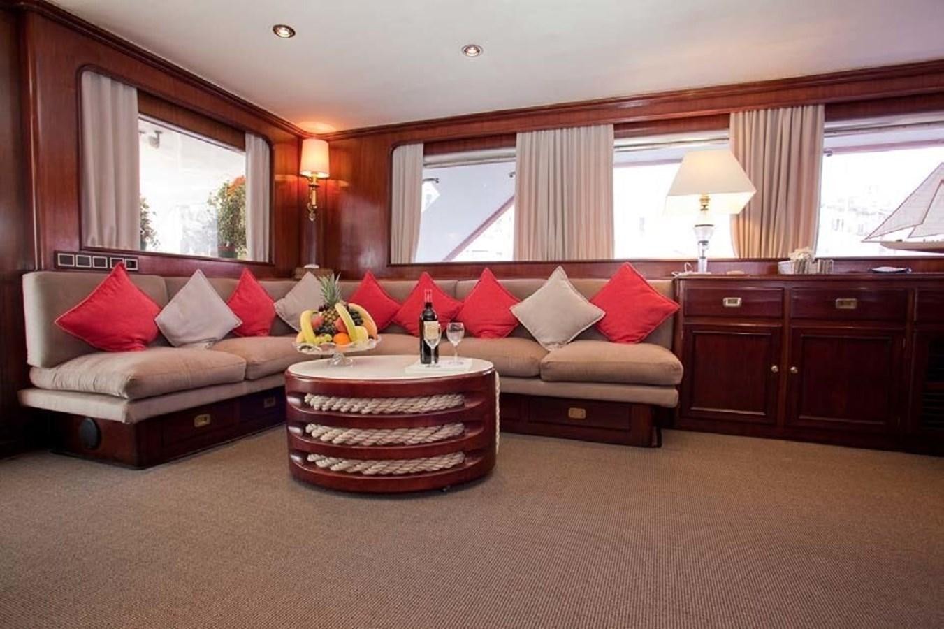 a living room with a couch and a table aboard MISS EVA Yacht for Sale