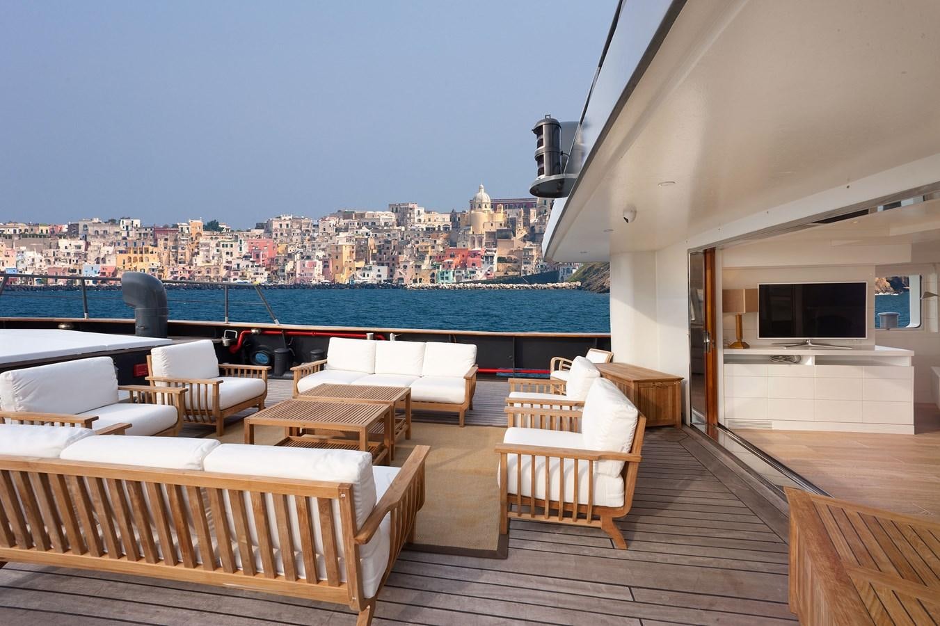 a deck with a view of a city and a body of water aboard VERVECE Yacht for Charter