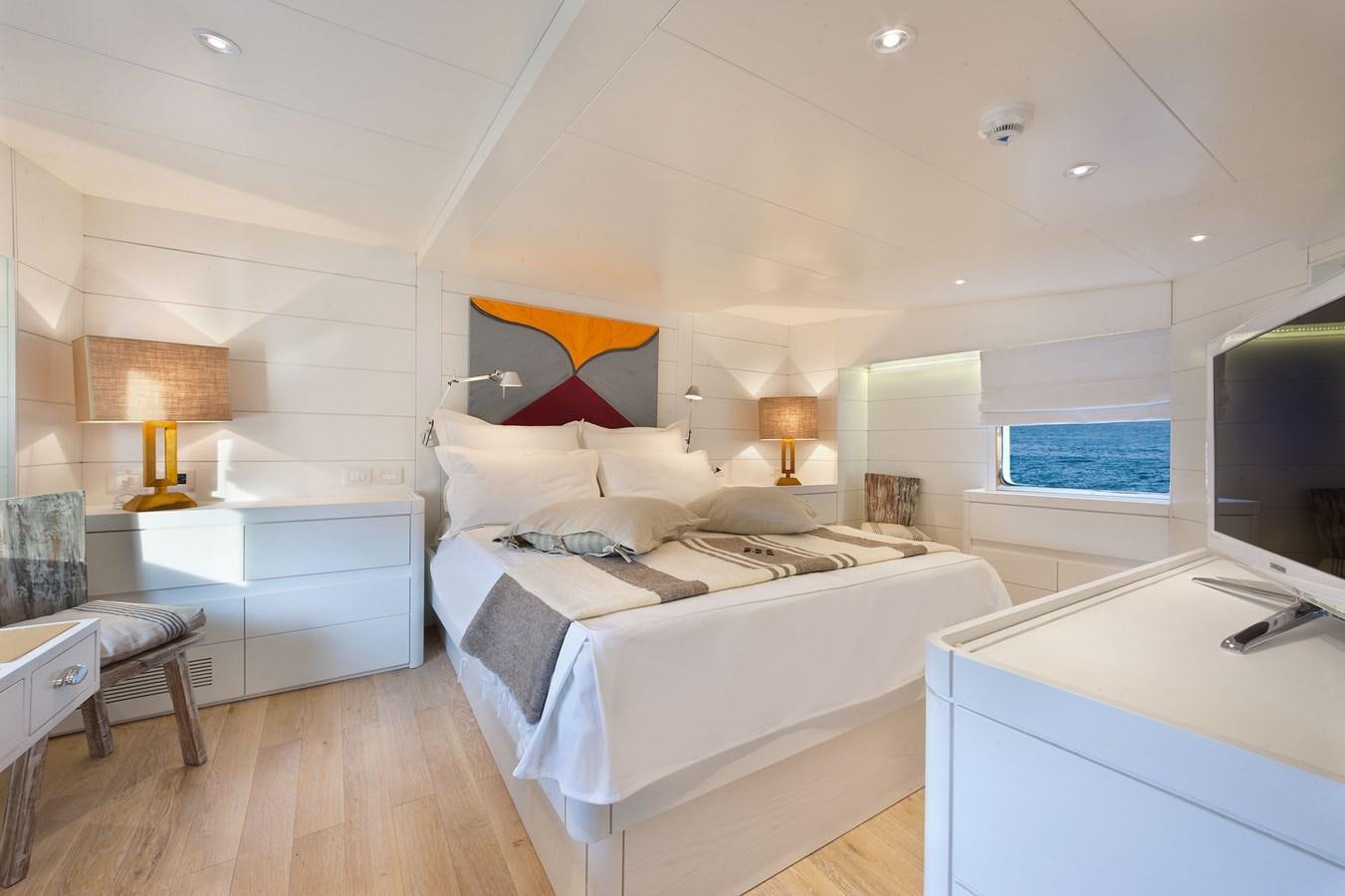 a room with a bed and a tv aboard VERVECE Yacht for Charter