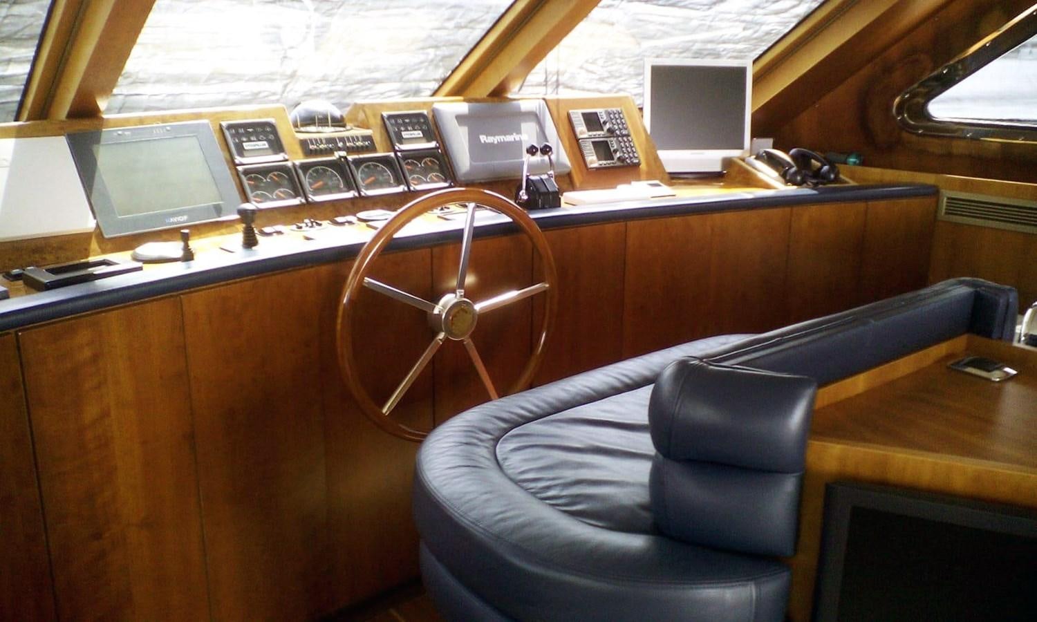 a room with a leather chair and a desk with a computer and other items on it aboard GIAVA Yacht for Sale