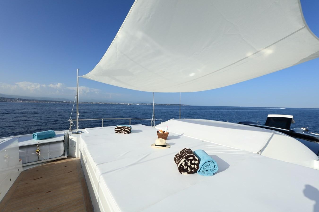 a white boat on a body of water aboard ASTRO Yacht for Sale