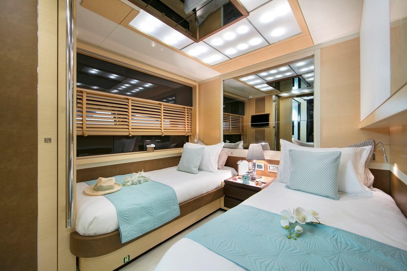 a room with beds and a window aboard ASTRO Yacht for Sale