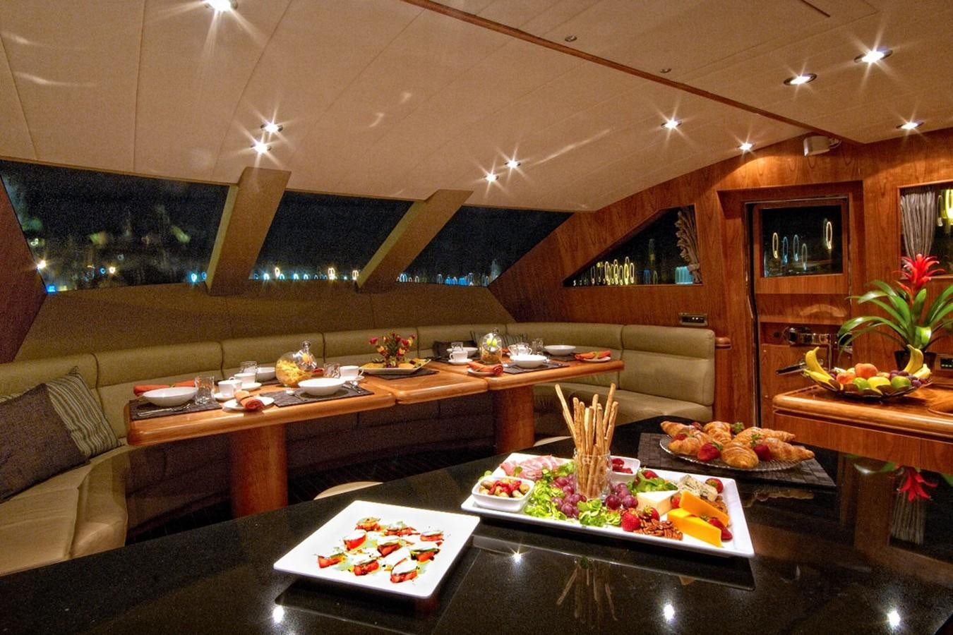 a large kitchen with a table and food on the table aboard TRIPLE 888 EIGHT Yacht for Sale