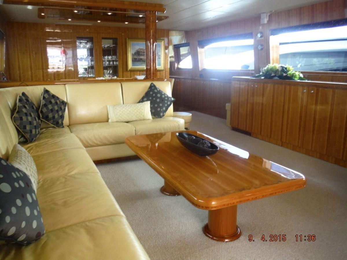 a living room with couches and a coffee table aboard TRIPLE 888 EIGHT Yacht for Sale