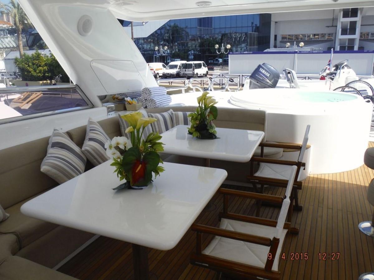 a table with chairs and a plant on it aboard TRIPLE 888 EIGHT Yacht for Sale