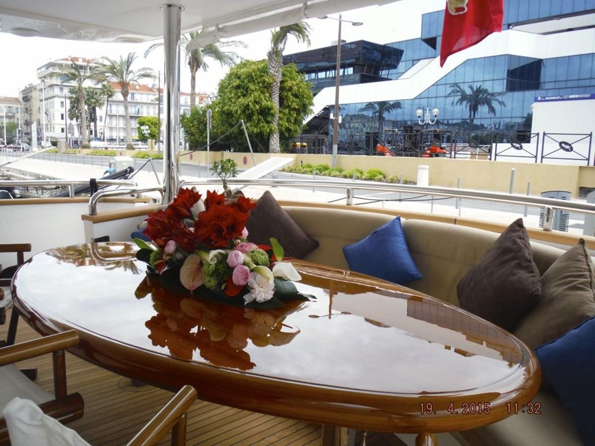 a table with flowers on it aboard TRIPLE 888 EIGHT Yacht for Sale