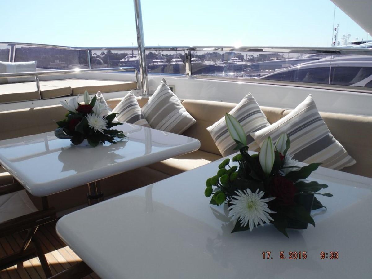 a table with white flowers and a black and white umbrella on it aboard TRIPLE 888 EIGHT Yacht for Sale