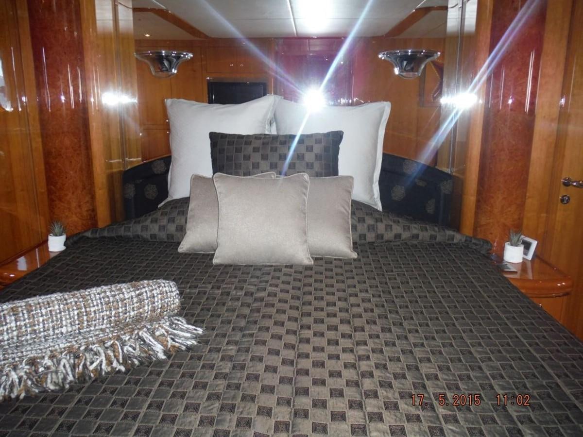 a bed with a checkered comforter aboard TRIPLE 888 EIGHT Yacht for Sale