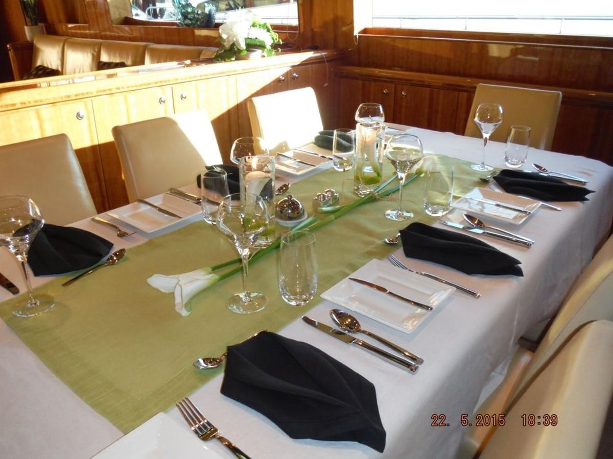 a table with wine glasses and napkins on it aboard TRIPLE 888 EIGHT Yacht for Sale