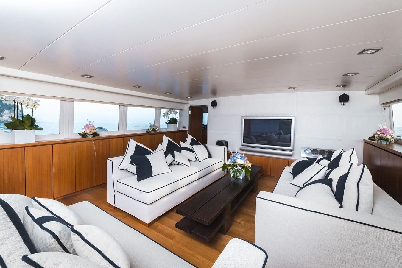 a living room with a couch and a television aboard PAOLUCCI Yacht for Sale