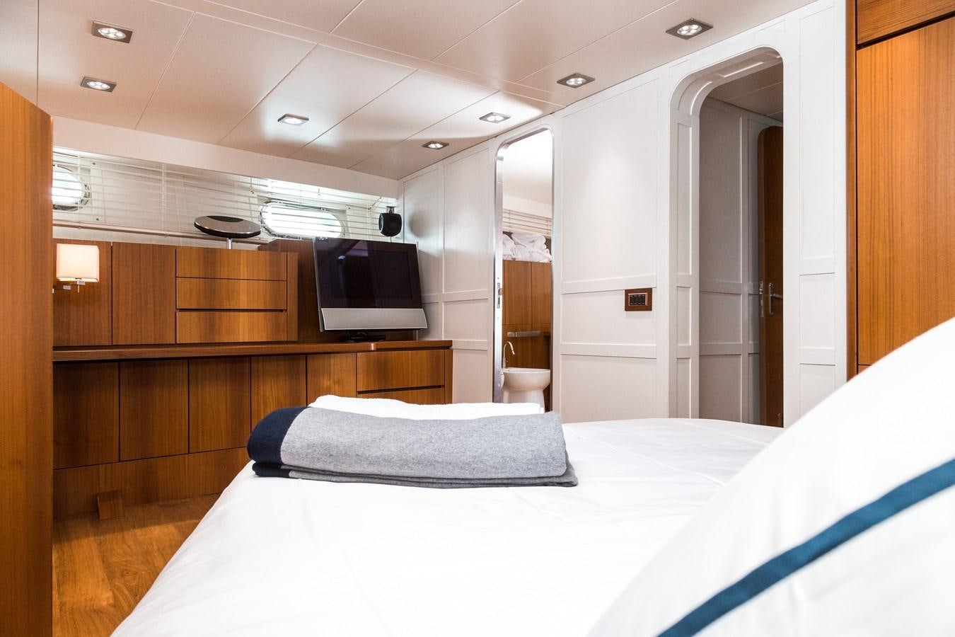 a room with a bed and a television aboard PAOLUCCI Yacht for Sale