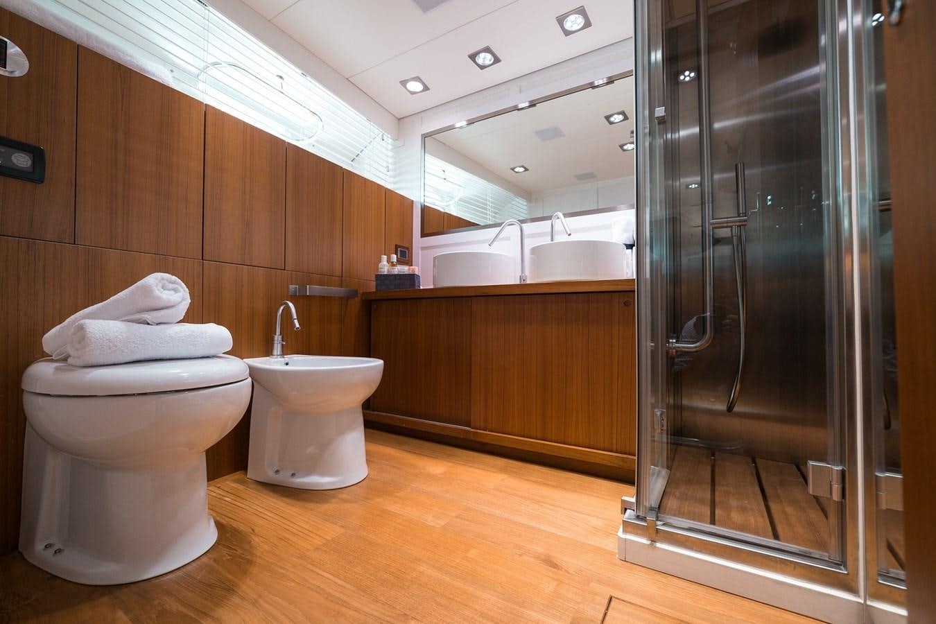 a bathroom with a glass shower aboard PAOLUCCI Yacht for Sale
