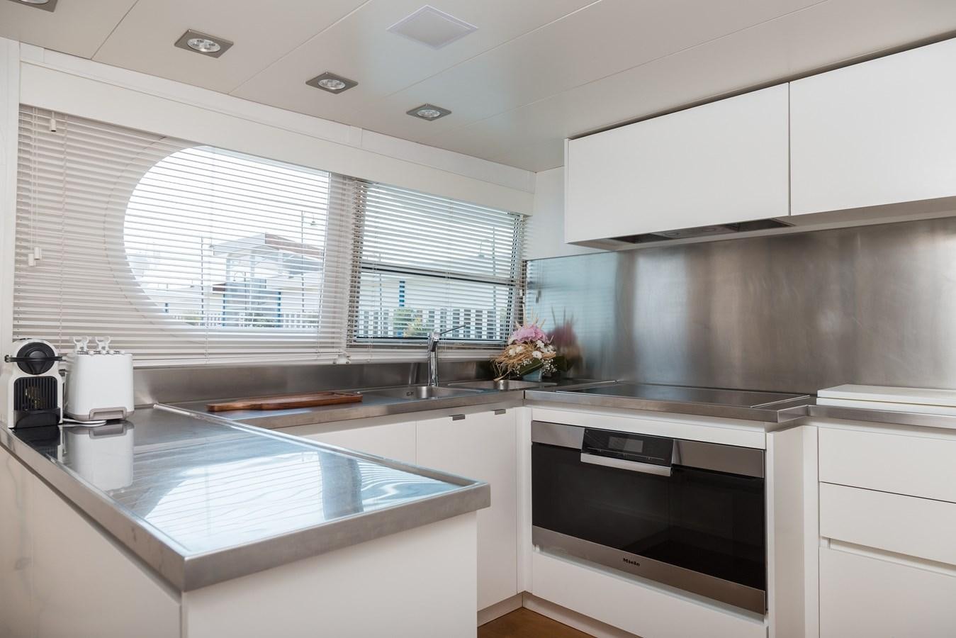 a kitchen with a large window aboard PAOLUCCI Yacht for Sale