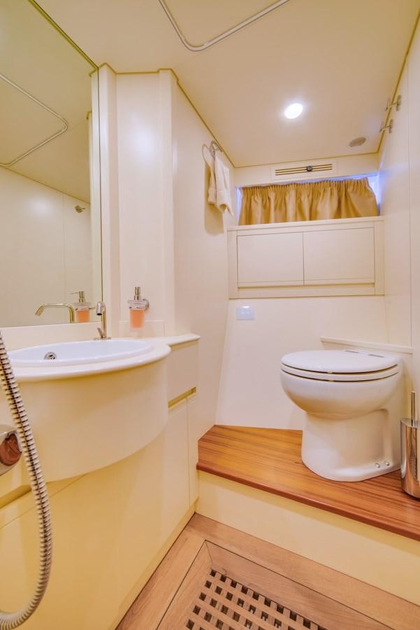 a bathroom with a toilet sink and a mirror aboard GERRY'S FERRY Yacht for Sale