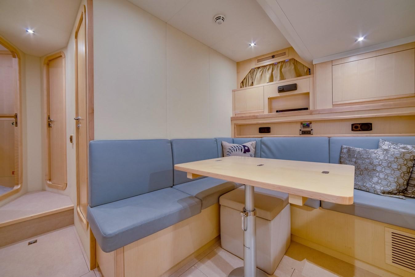 a room with a table and couch aboard GERRY'S FERRY Yacht for Sale
