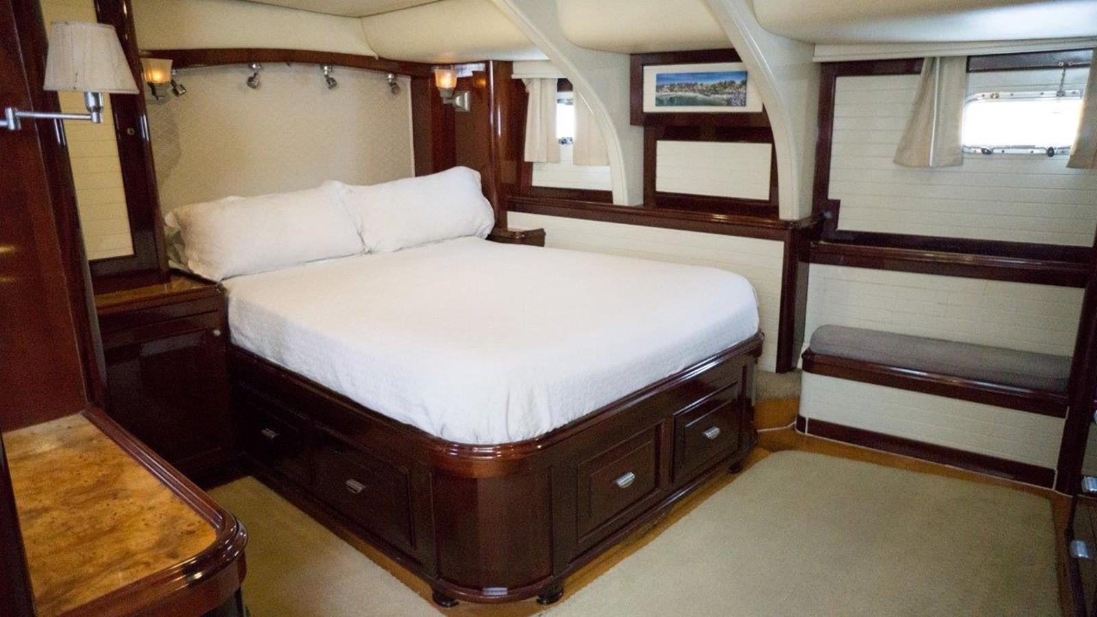 a bedroom with a bed and a desk aboard ODYSSEUS Yacht for Sale