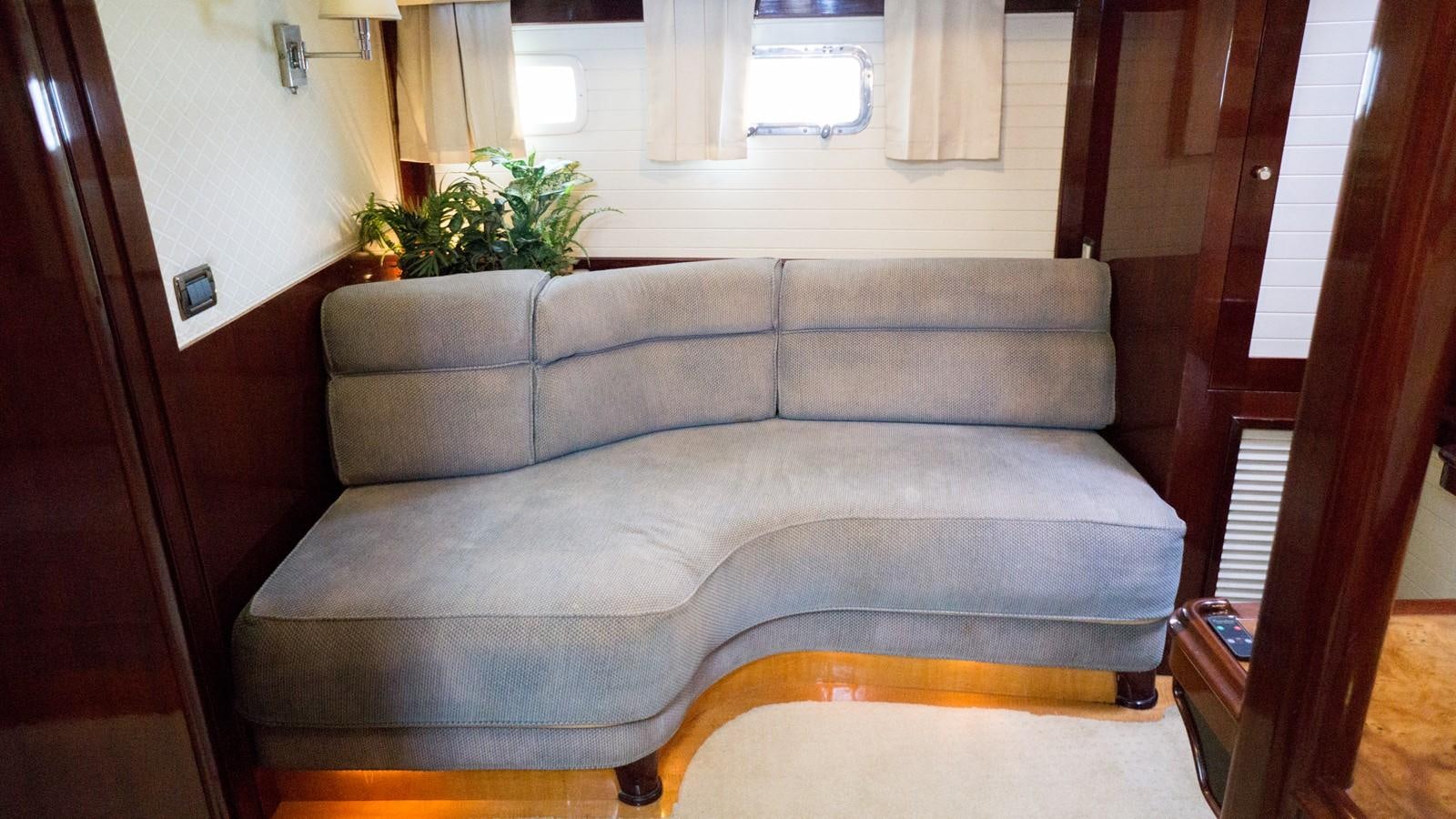 a couch in a room aboard ODYSSEUS Yacht for Sale