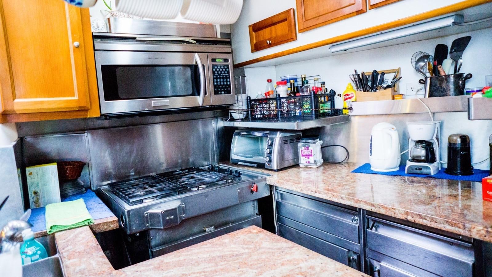 a kitchen with a microwave oven and a coffee maker aboard ODYSSEUS Yacht for Sale