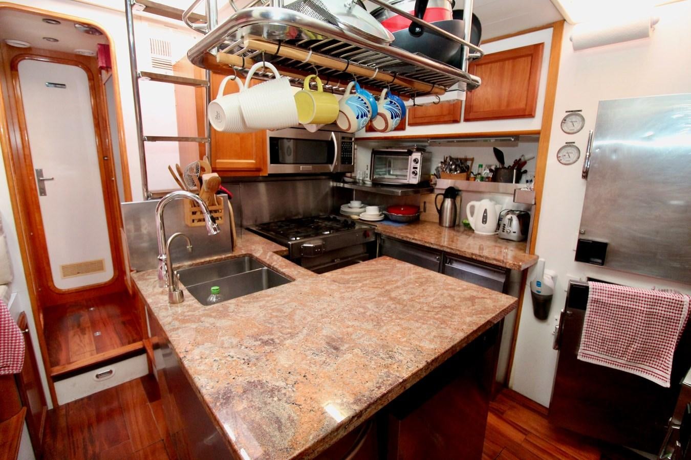 a kitchen with a sink and stove aboard ODYSSEUS Yacht for Sale