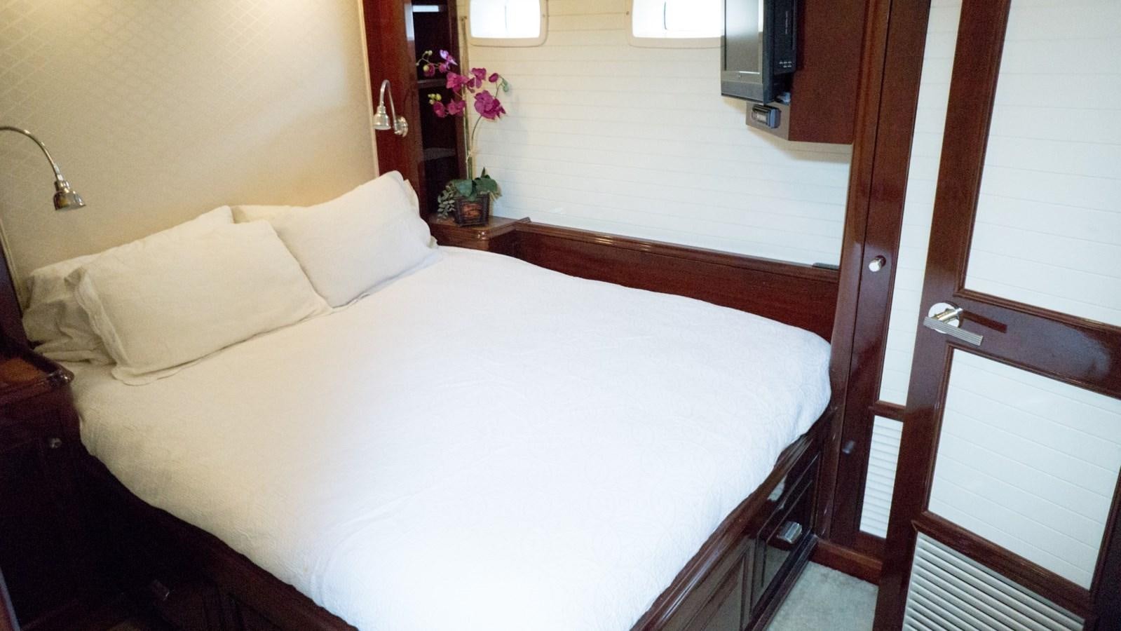 a bed with white sheets aboard ODYSSEUS Yacht for Sale