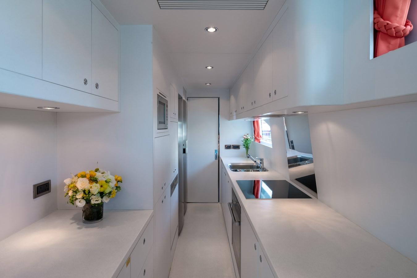 a kitchen with white cabinets aboard VICTORIOUS Yacht for Charter
