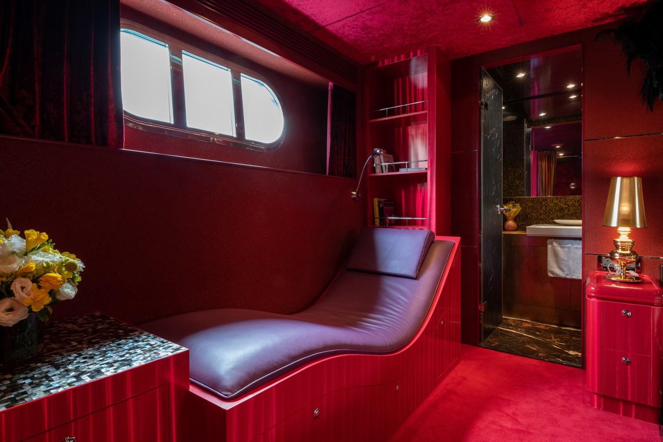 a room with a couch and a mirror aboard VICTORIOUS Yacht for Charter