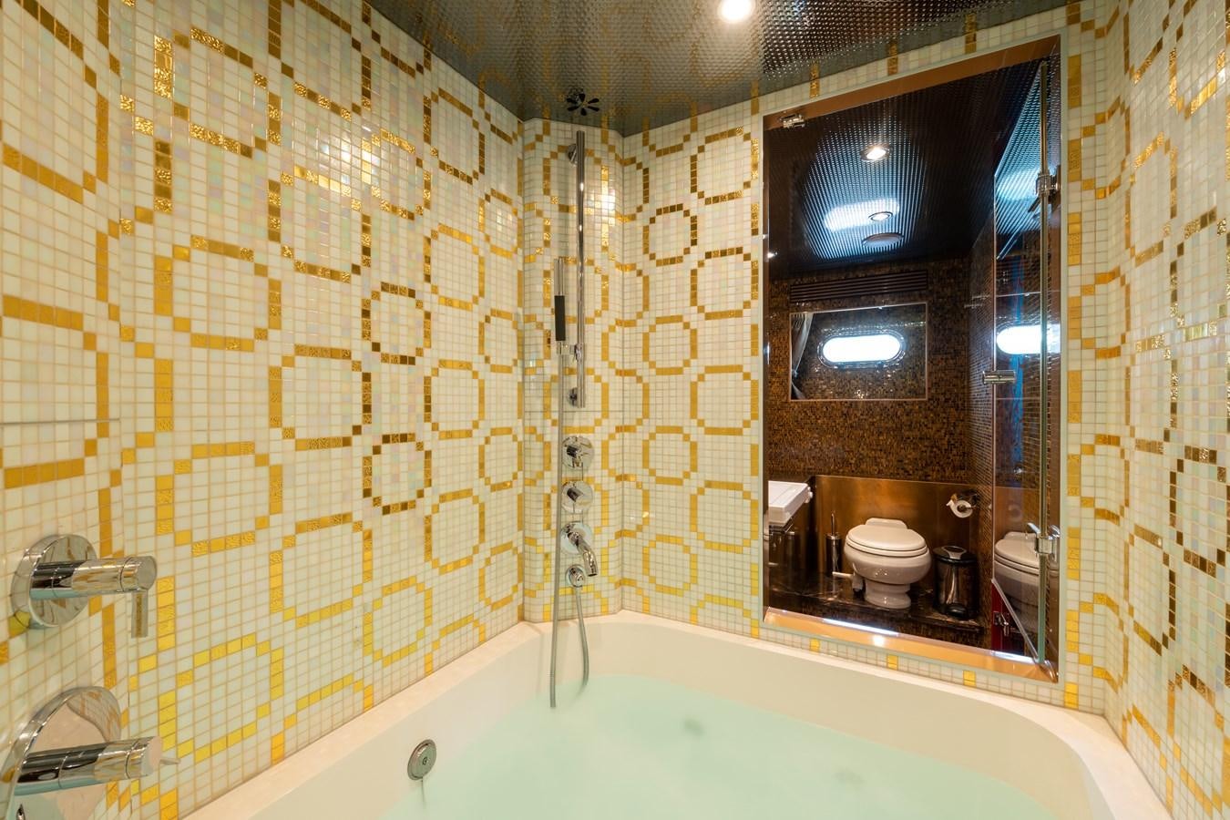 a bathroom with a bathtub and toilet aboard VICTORIOUS Yacht for Charter