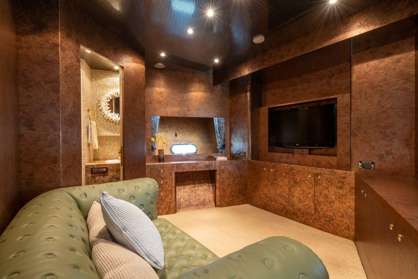 a room with a bed and a television aboard VICTORIOUS Yacht for Charter