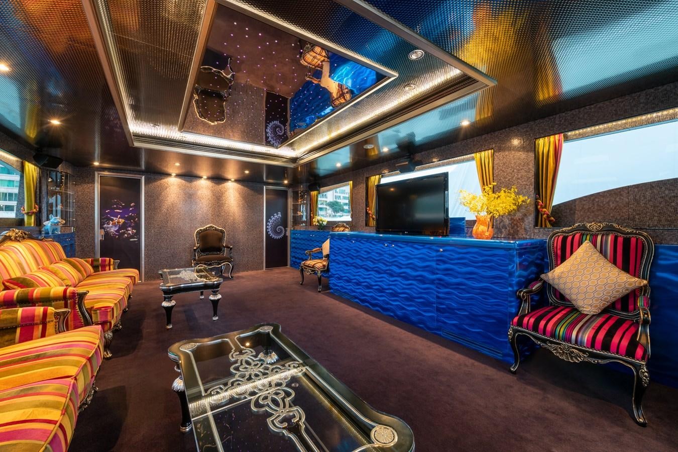 a room with a bed and a couch aboard VICTORIOUS Yacht for Charter