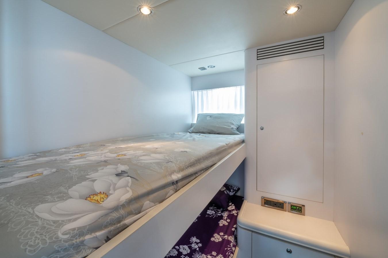 a bedroom with a bed and a closet aboard VICTORIOUS Yacht for Charter