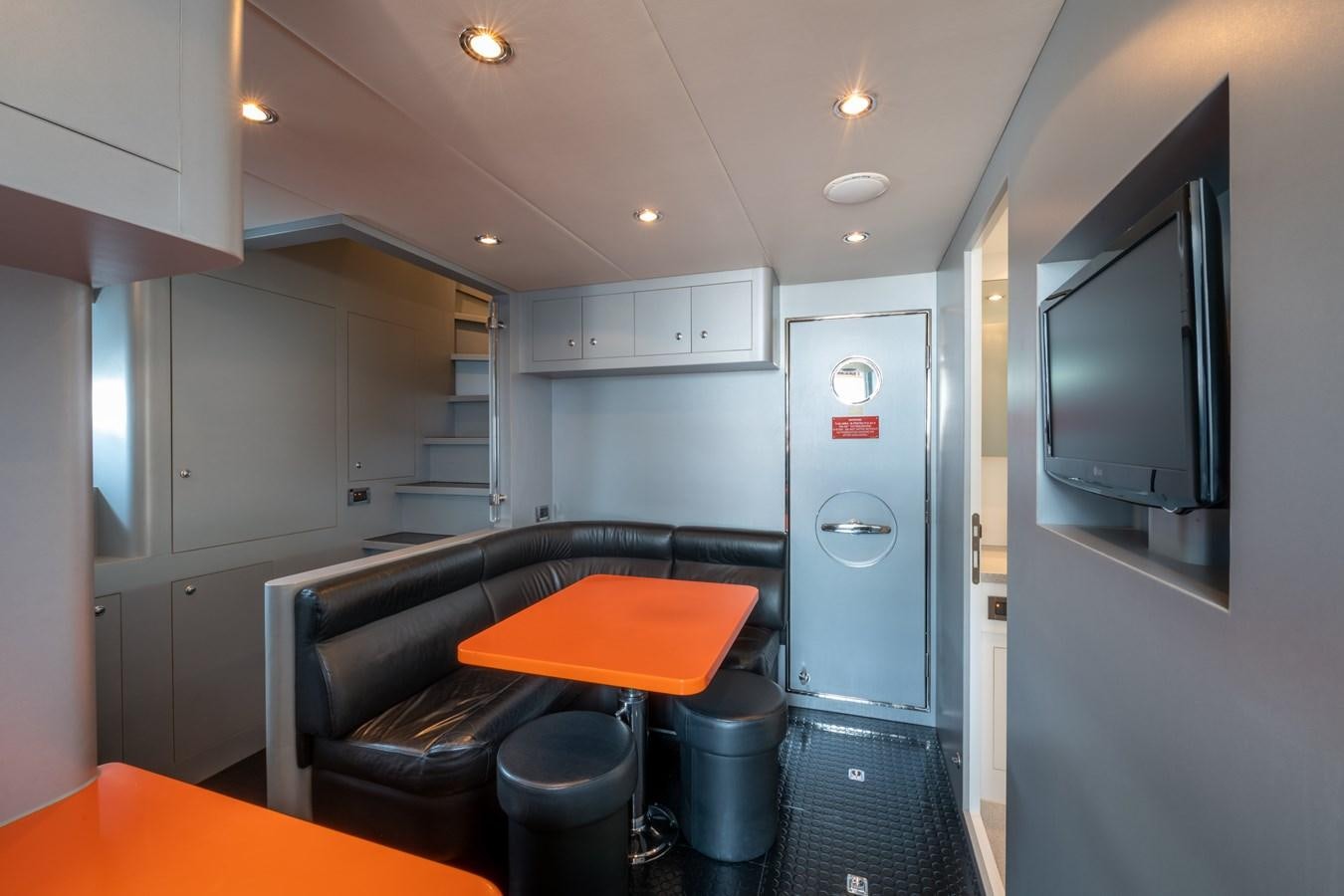 a room with a desk and a tv aboard VICTORIOUS Yacht for Charter