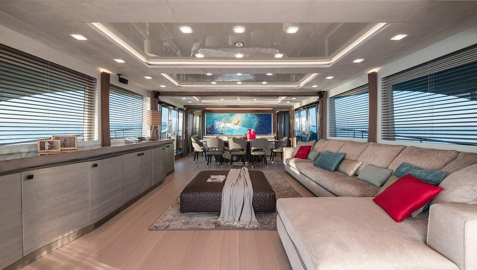 a large living room with a large sofa and a tv aboard MONTE CARLO YACHTS MCY 96 Yacht for Sale