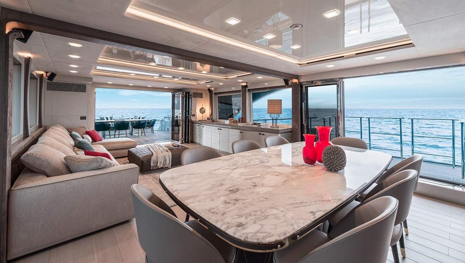 a large living room with a large table and chairs aboard MONTE CARLO YACHTS MCY 96 Yacht for Sale