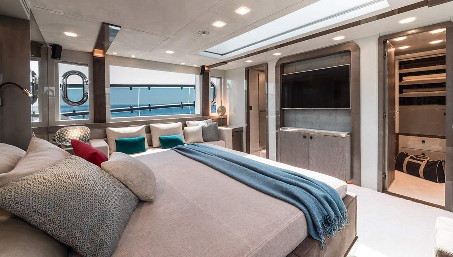 a room with a bed and a tv aboard MONTE CARLO YACHTS MCY 96 Yacht for Sale