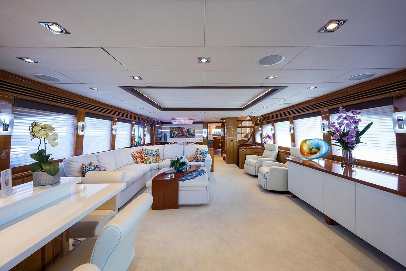 a large living room with white furniture aboard OSSUM DREAM Yacht for Sale