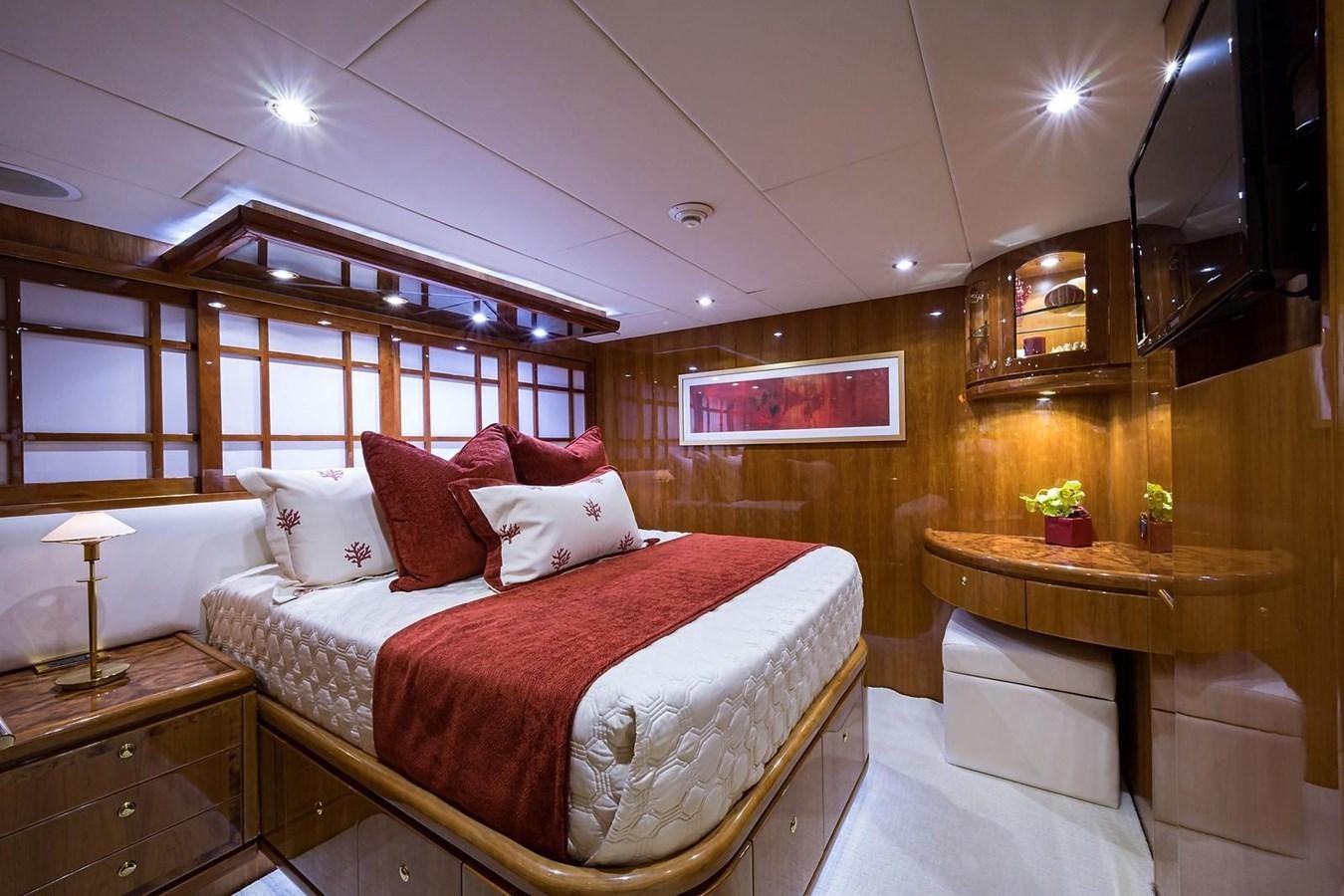 a bedroom with a bed and a desk aboard OSSUM DREAM Yacht for Sale