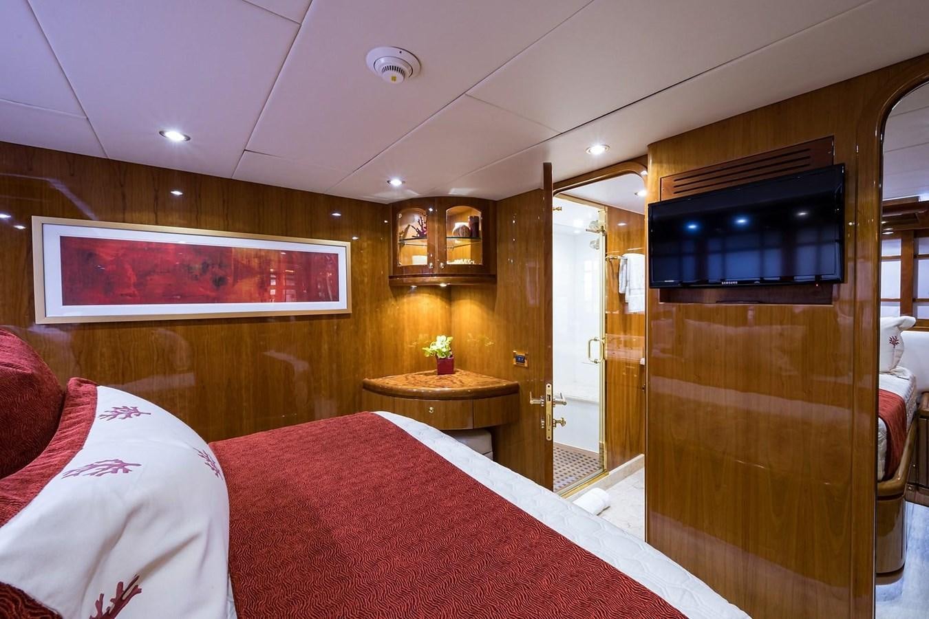 a bedroom with a bed and a desk aboard OSSUM DREAM Yacht for Sale