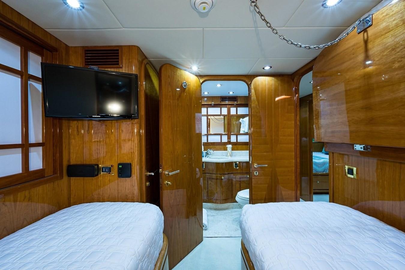 a room with a bed and a television aboard OSSUM DREAM Yacht for Sale