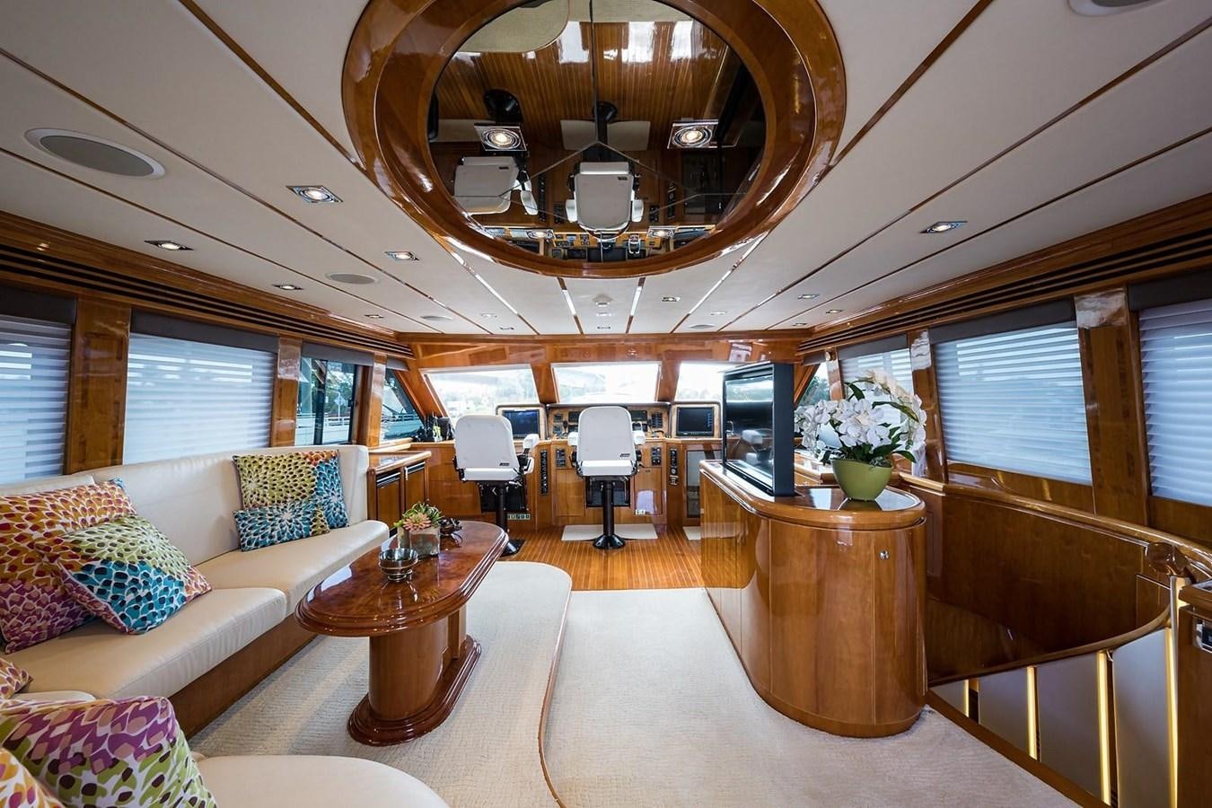 a large living room with a large chandelier aboard OSSUM DREAM Yacht for Sale