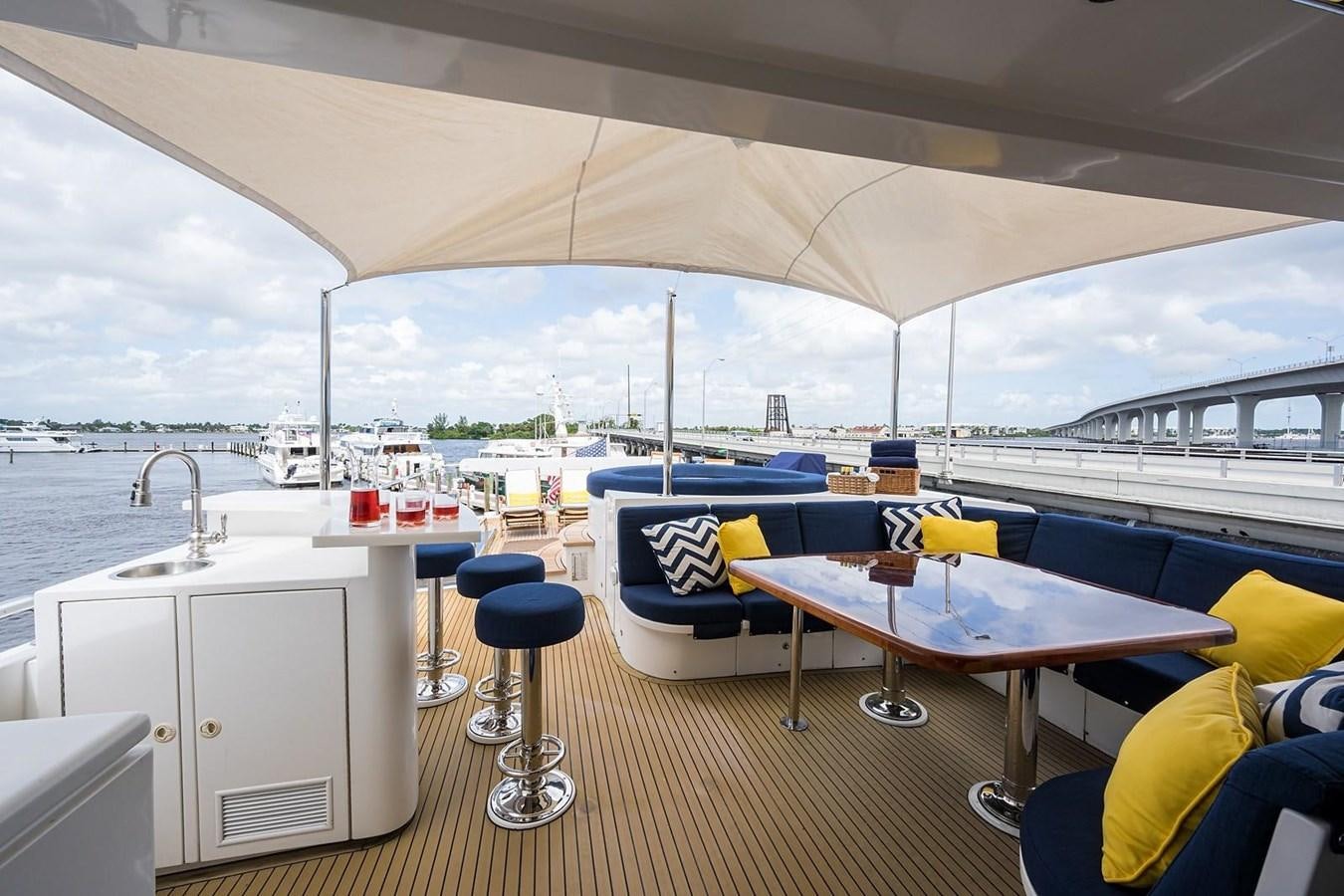 a table and chairs on a deck aboard OSSUM DREAM Yacht for Sale