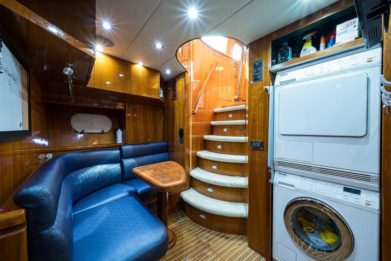 a living room with a couch and a bed aboard OSSUM DREAM Yacht for Sale
