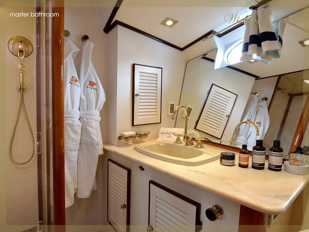 a bathroom with a robe on the wall aboard WIND OF CHANGE Yacht for Sale