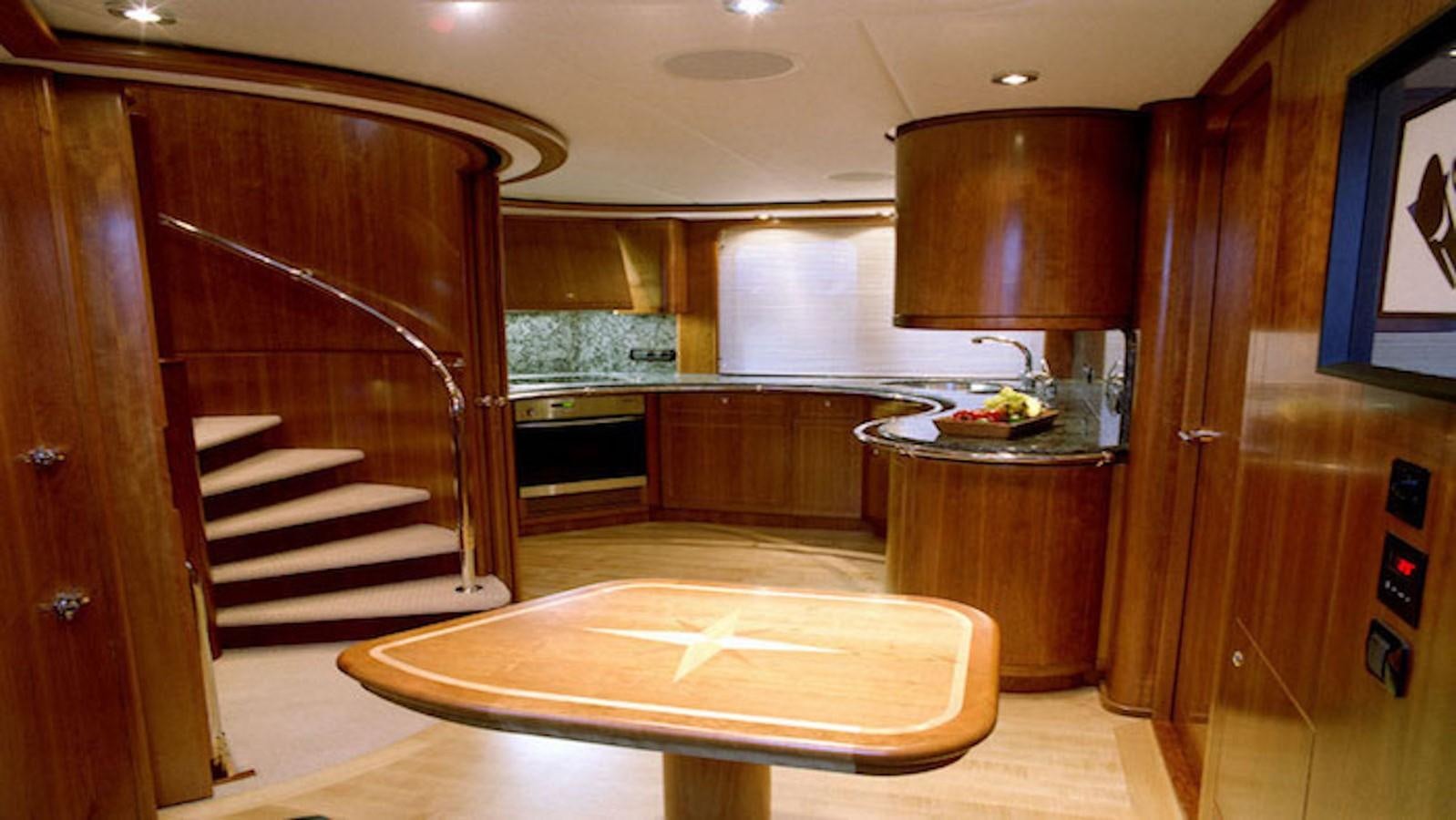 a room with a table and stairs aboard MAVERICK Yacht for Sale