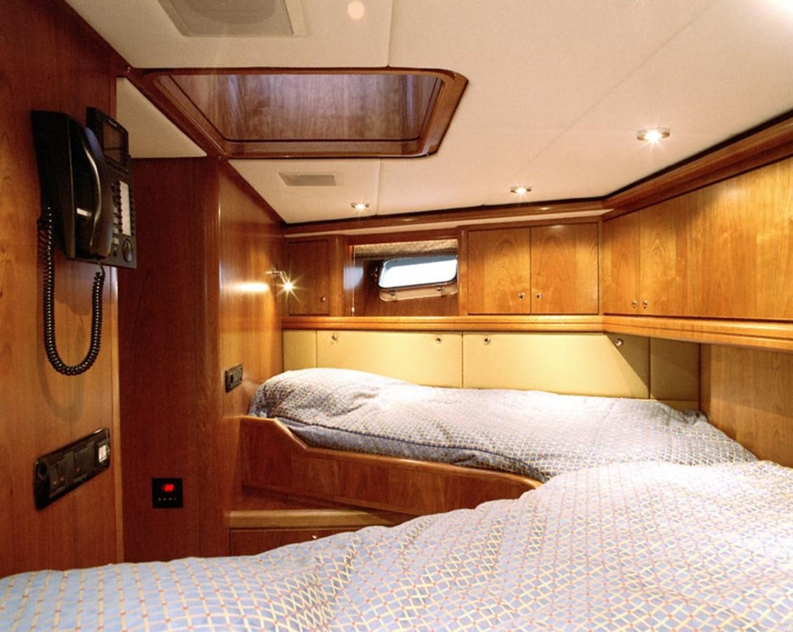 a bed with a telephone on the wall aboard MAVERICK Yacht for Sale
