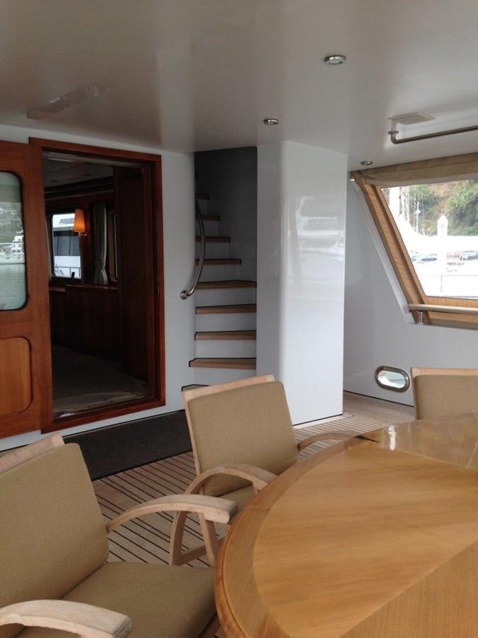 a living room with a staircase aboard MAVERICK Yacht for Sale