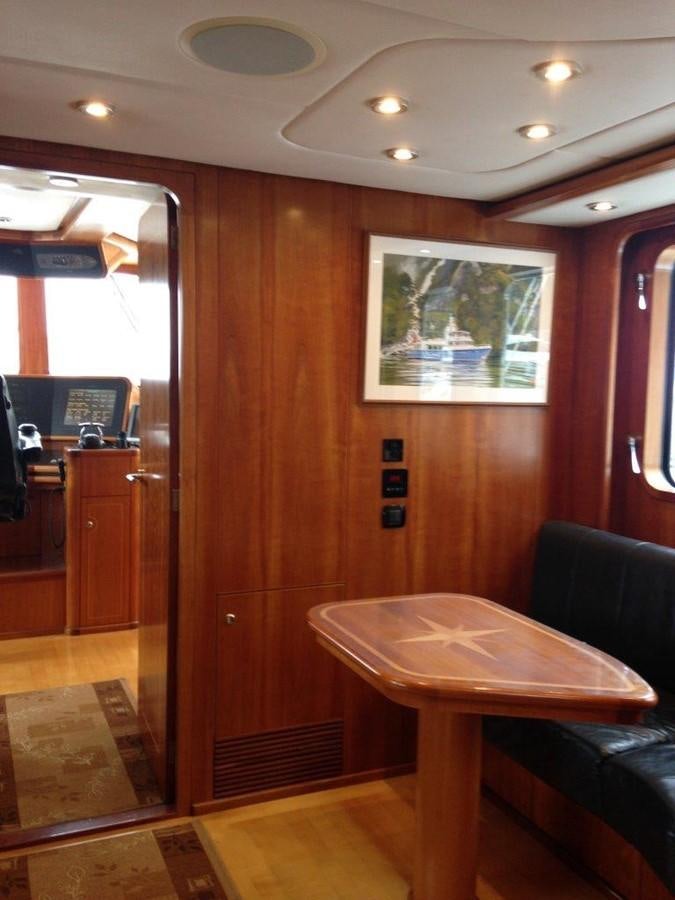 a room with a table and chairs aboard MAVERICK Yacht for Sale