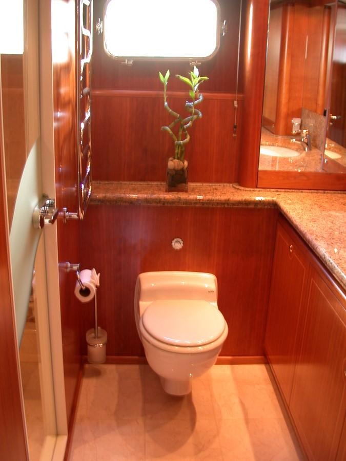 a bathroom with a toilet and a sink aboard MAVERICK Yacht for Sale