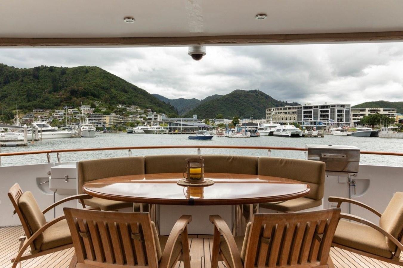 a table on a balcony overlooking a body of water aboard MAVERICK Yacht for Sale